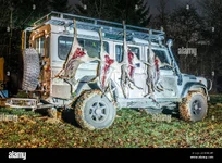 hunting-stretch-with-roe-deer-hanging-on-a-off-road-vehicle-KX6CWF.jpg
